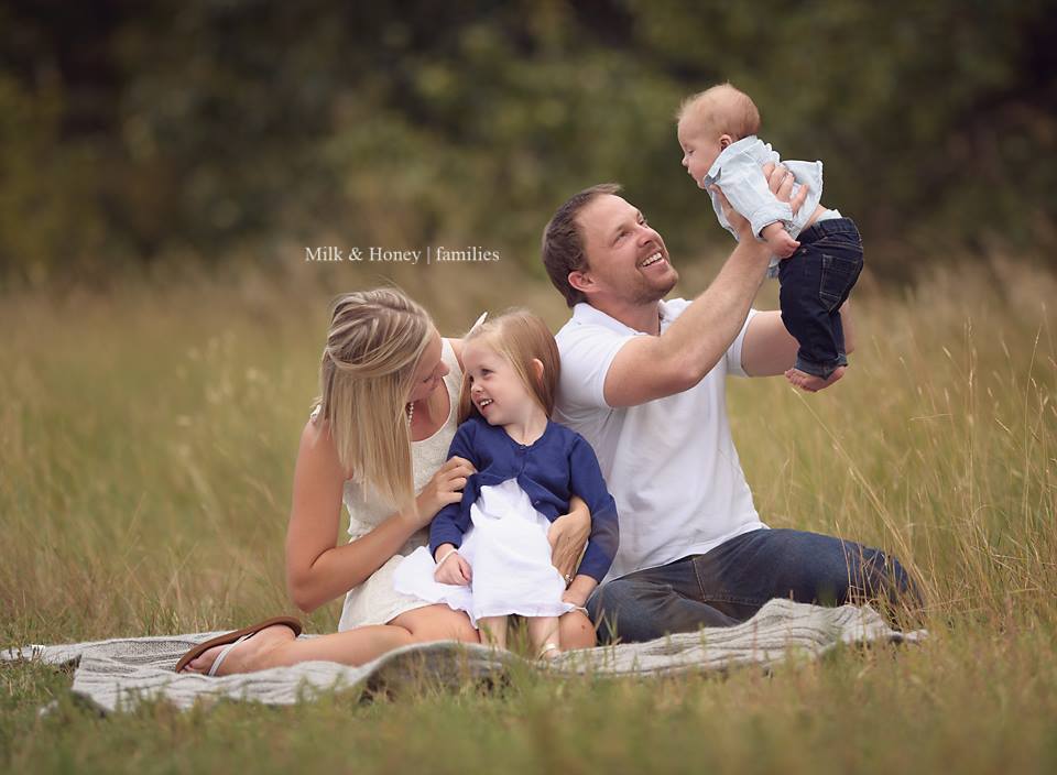 family posing with baby and toddler
