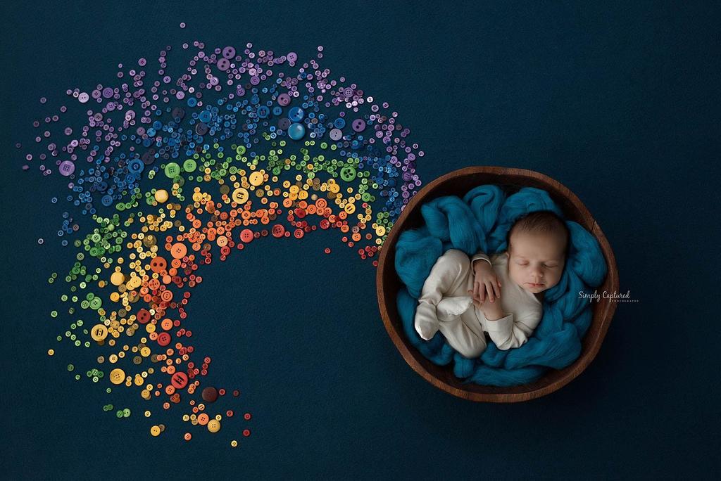 baby in bowl at the end of a button rainbow