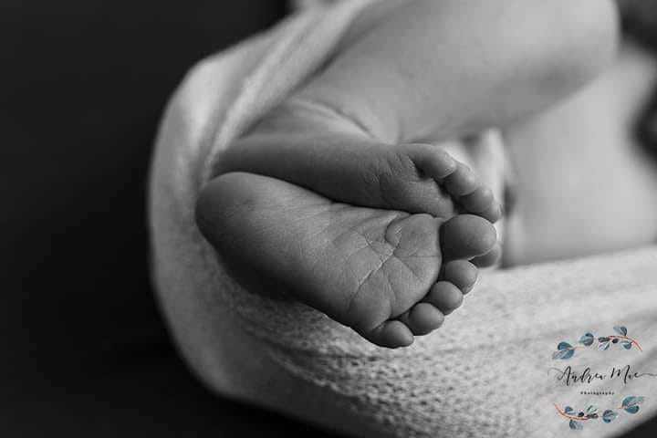 newborn toes peeking from wrap