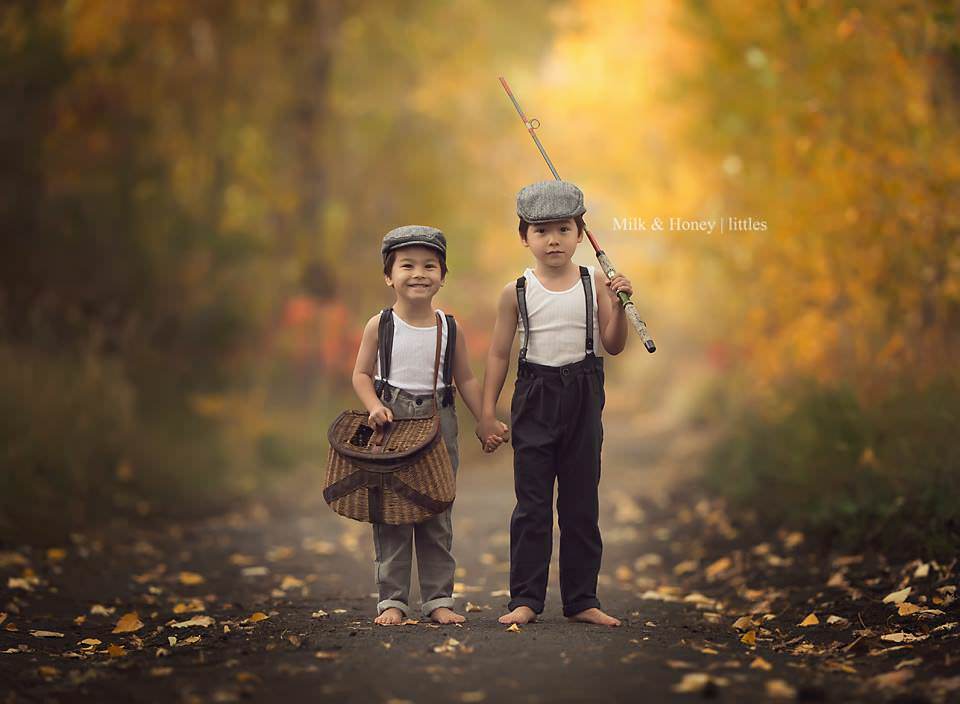 boys walking amongst fall trees in vintage outfits