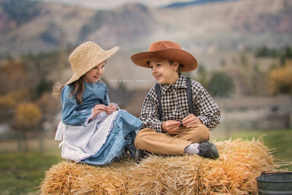 kids laughing on hay bale