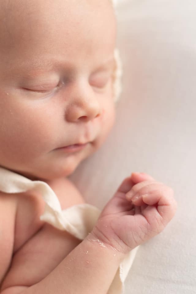 newborn baby with clutched fist