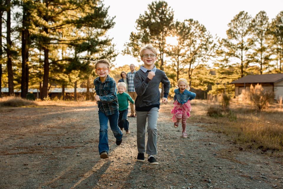 fun family photo with kids running to camera