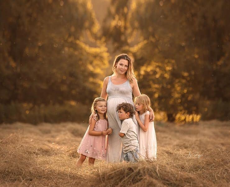 mom and three kids in family photo outdoors