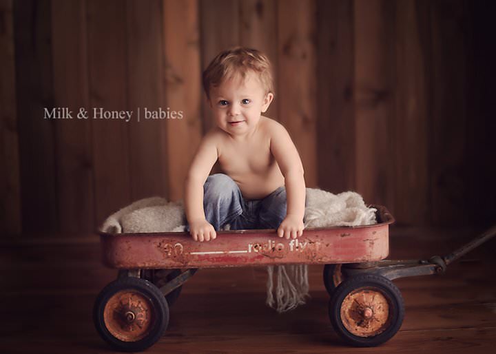 child climbing out of wagon in studio