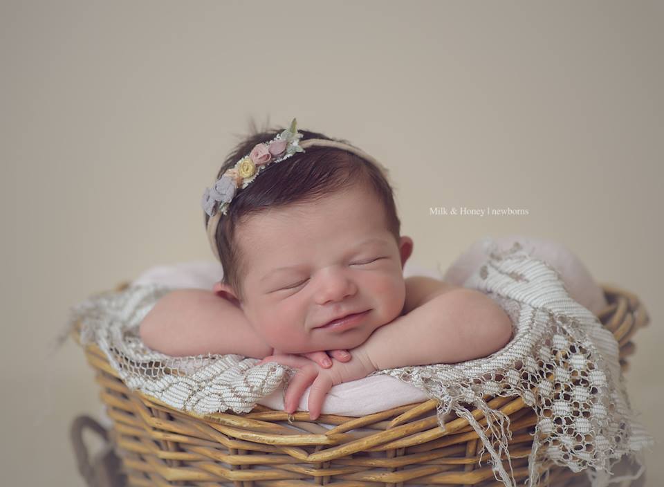 baby posed in basket prop