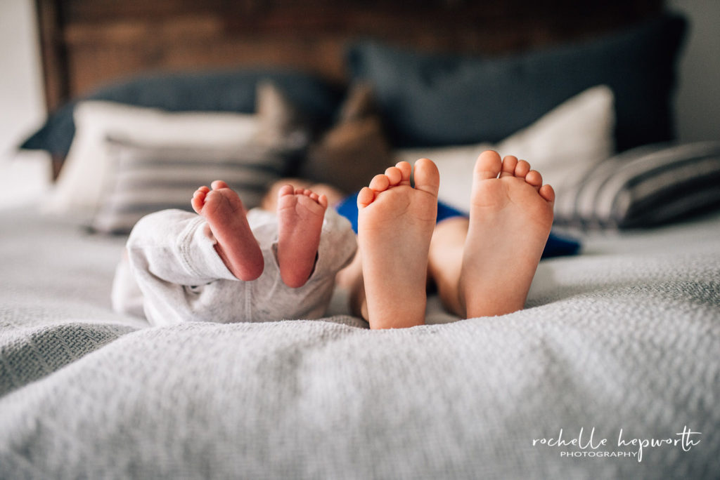 toddler and newborn feet