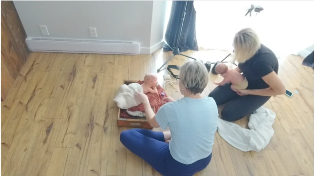spotter watching baby during newborn photography session